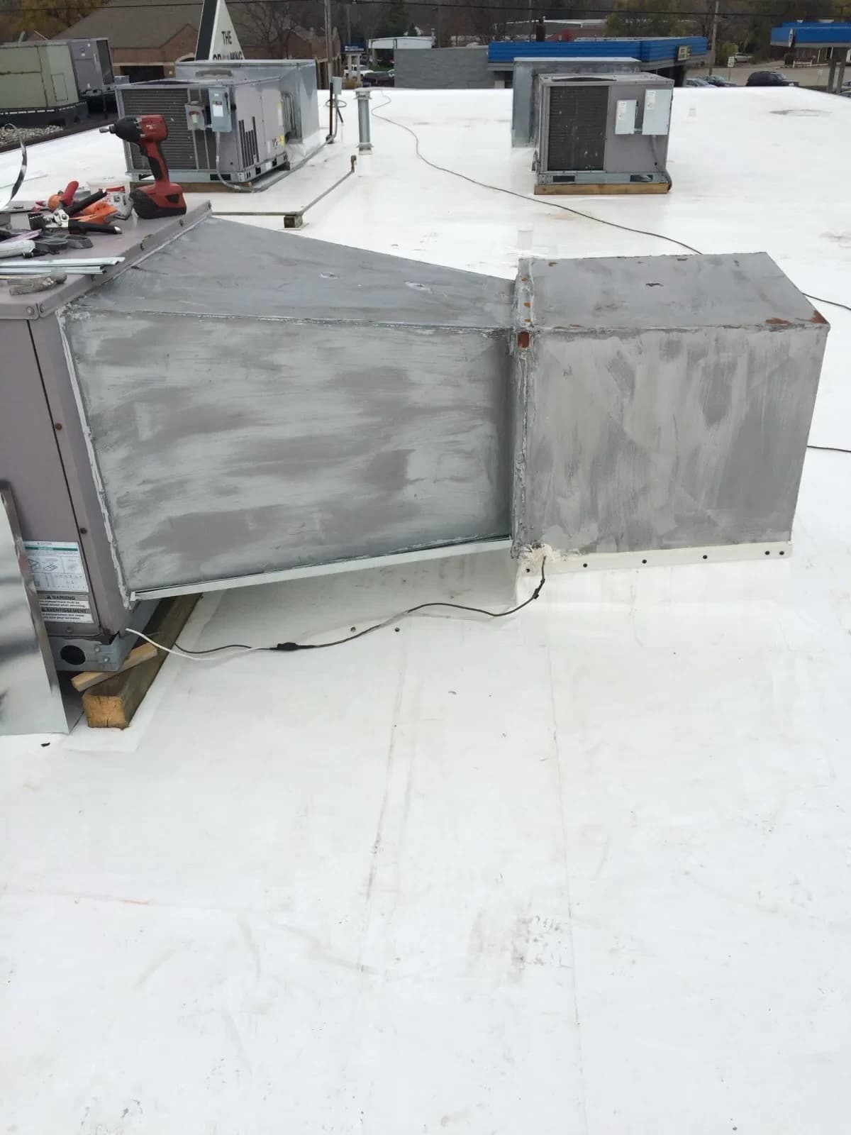 Mazure's technician repairing an air conditioning unit